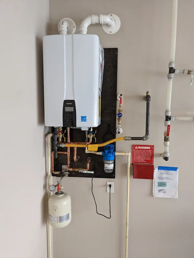 Professional plumber installing copper piping in a Dumbarton home